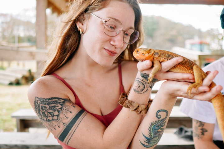 a woman with a lizard