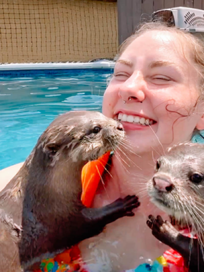 a person drinking water from a pool of water