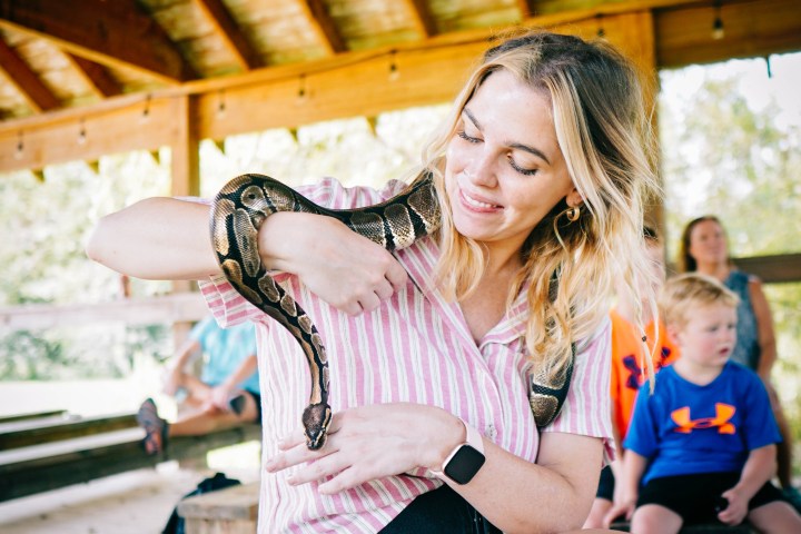 a woman sitting on a bench posing for the camera