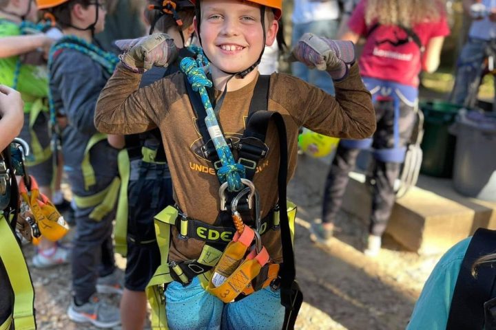 a group of people walking down a dirt road