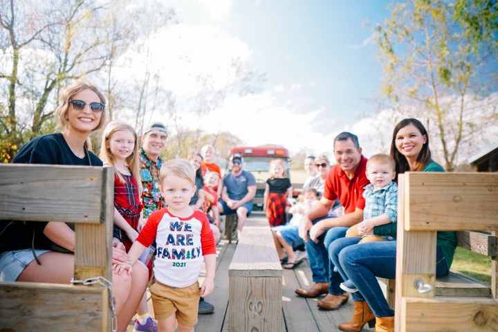 a group of people sitting on a wooden bench