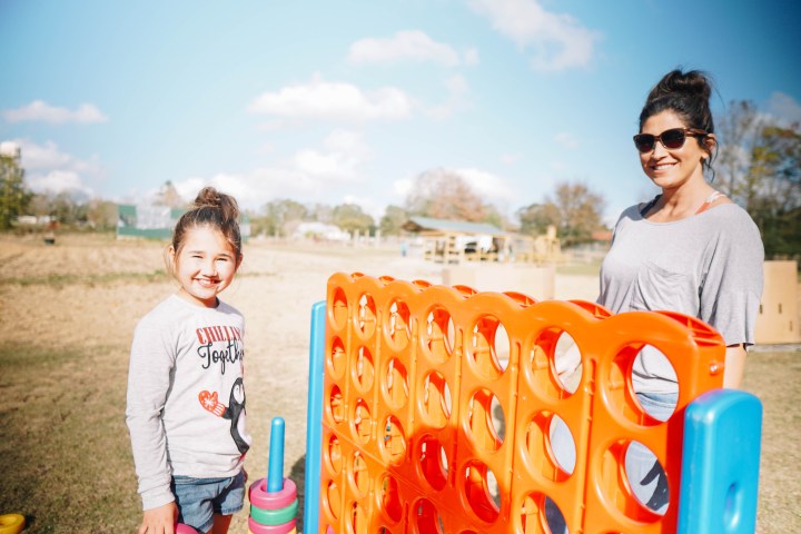 a man standing next to an orange